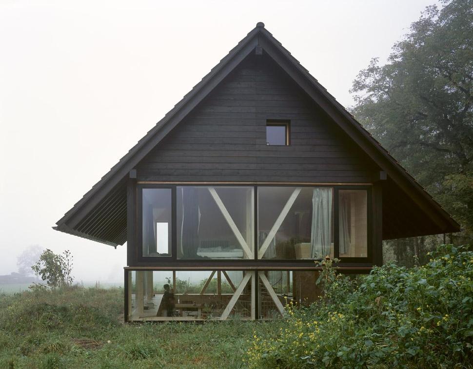 barn-home-floats-round-window-over-lower-facade-glass-8-exterior.jpg