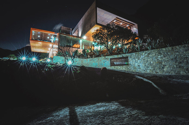 mountainside-home-made-with-aged-materials-8-front-angle-night.jpg