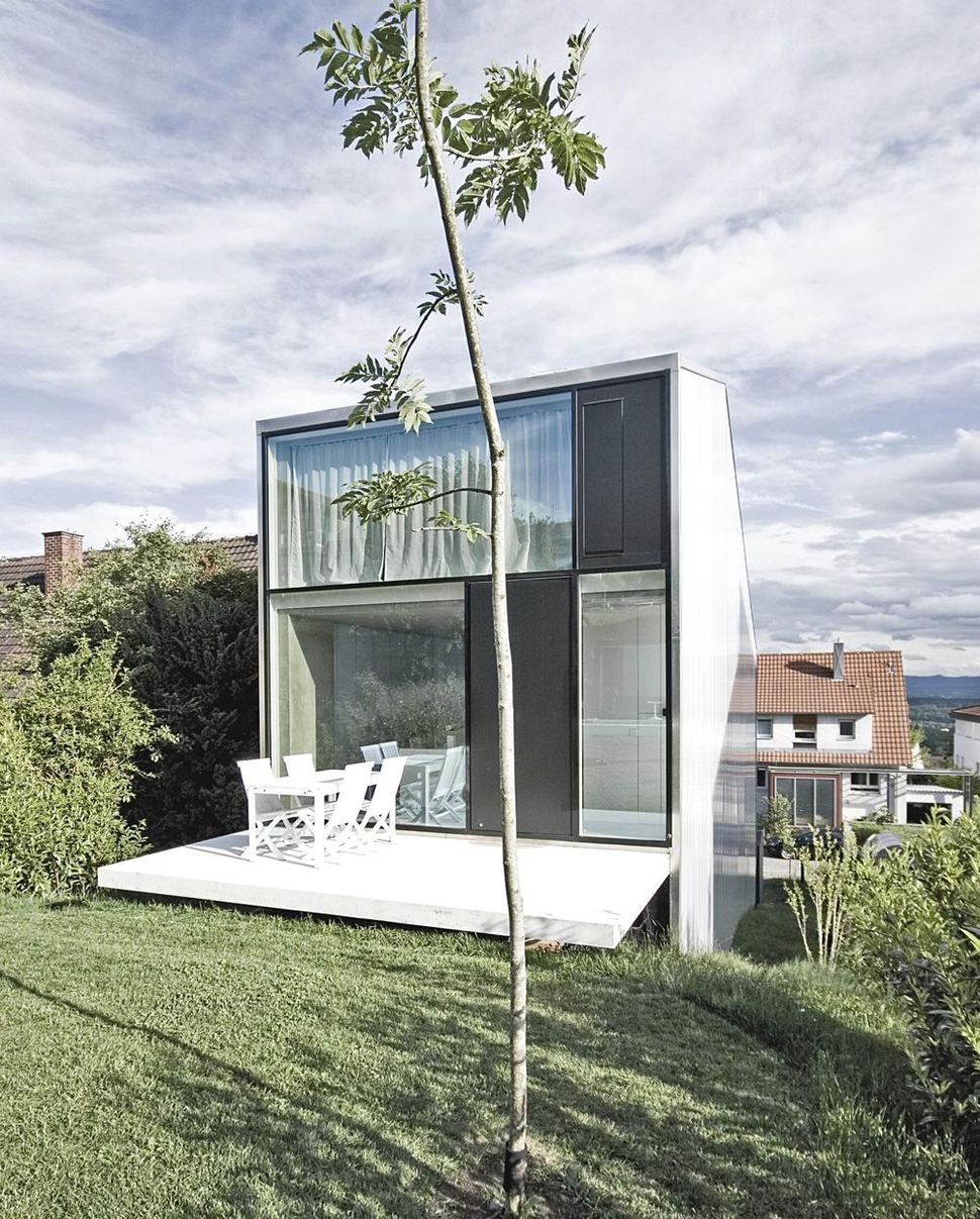 tall-minimalistic-hillside-house-built-from-concrete-2-deck-yard.jpg
