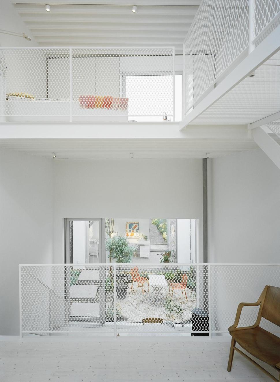 white-townhouse-with-open-interiors-detached-office-9-mesh-railings.jpg