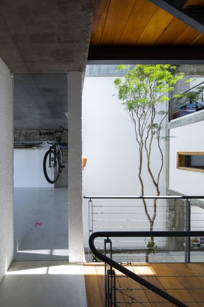 brazilian concrete house built around three story courtyard tree 4 garage hallway