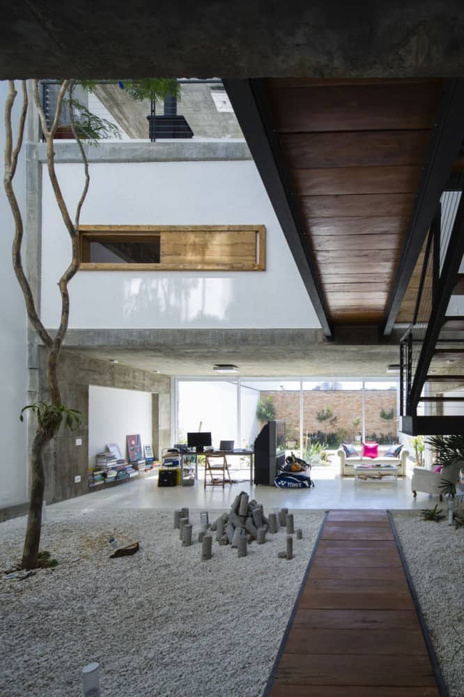 brazilian concrete house built around three story courtyard tree 8 ground level path