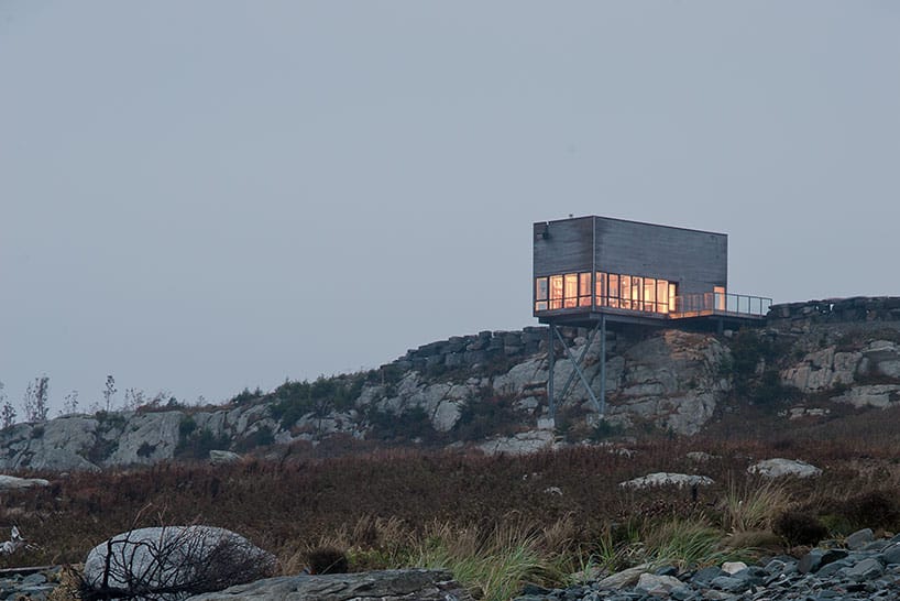 cantilevered cliff house with timber finishes 2 front far
