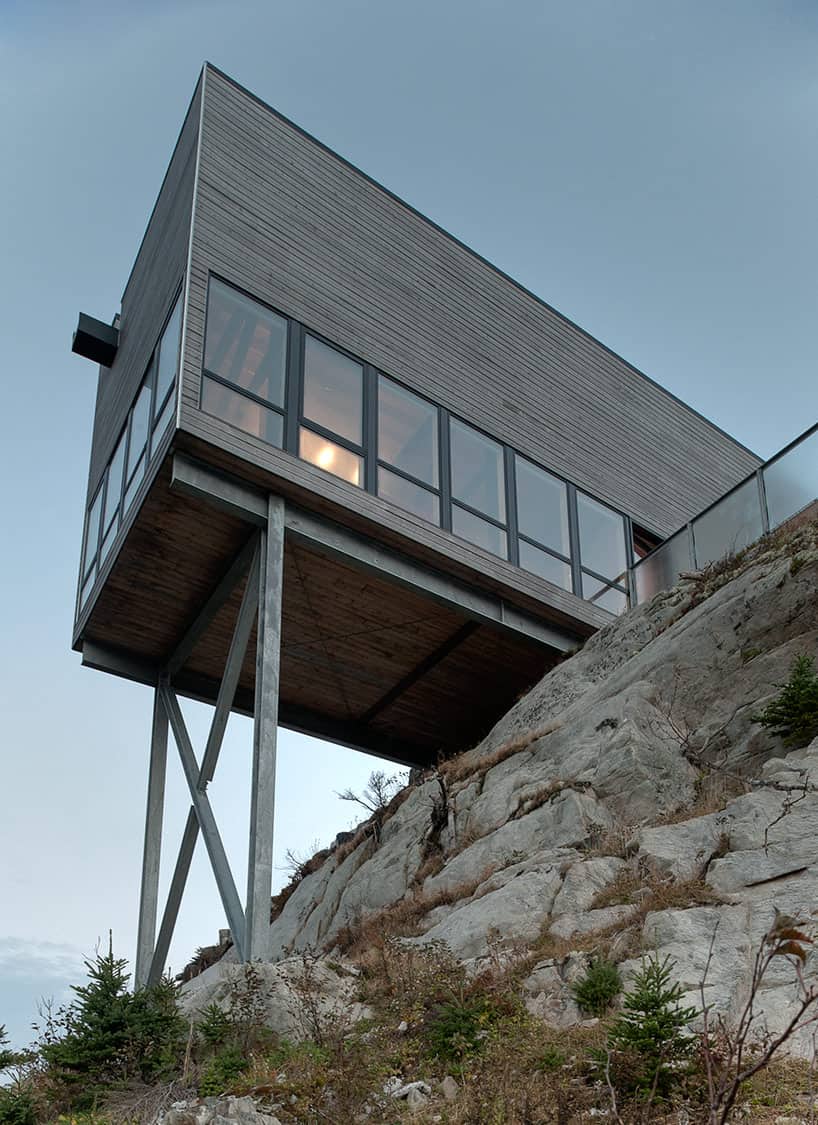 cantilevered cliff house with timber finishes 5 below close