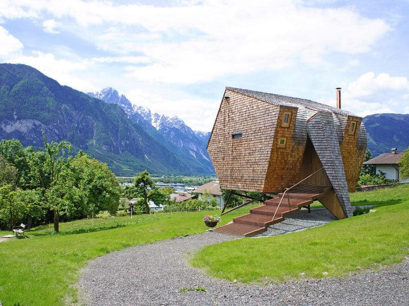 compact-irregularly-shaped-austrian-mountain-house-on-stilts-1-entry-path.jpg