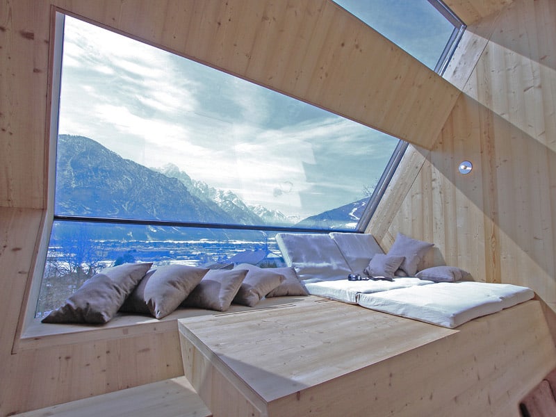 compact-irregularly-shaped-austrian-mountain-house-on-stilts-11-main-window.jpeg