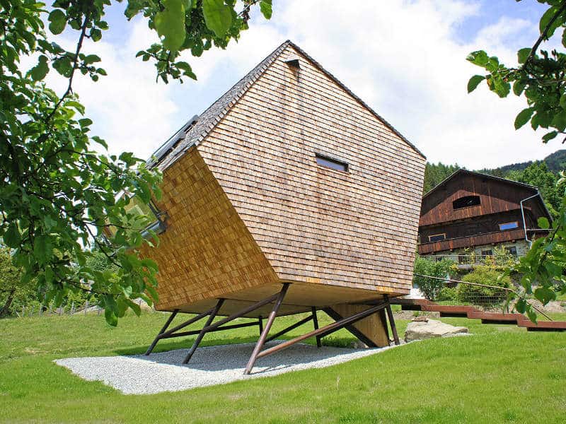 compact-irregularly-shaped-austrian-mountain-house-on-stilts-2-side-few-windows.jpg