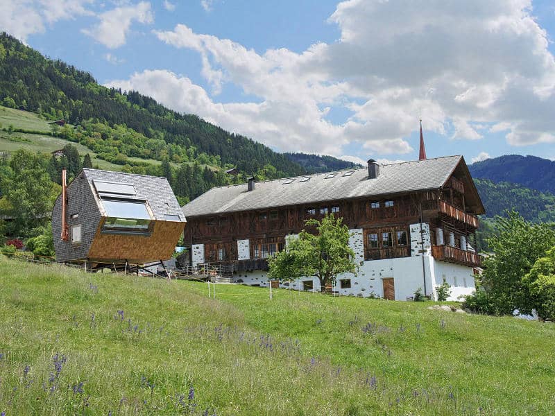 compact irregularly shaped austrian mountain house on stilts 4 below summer