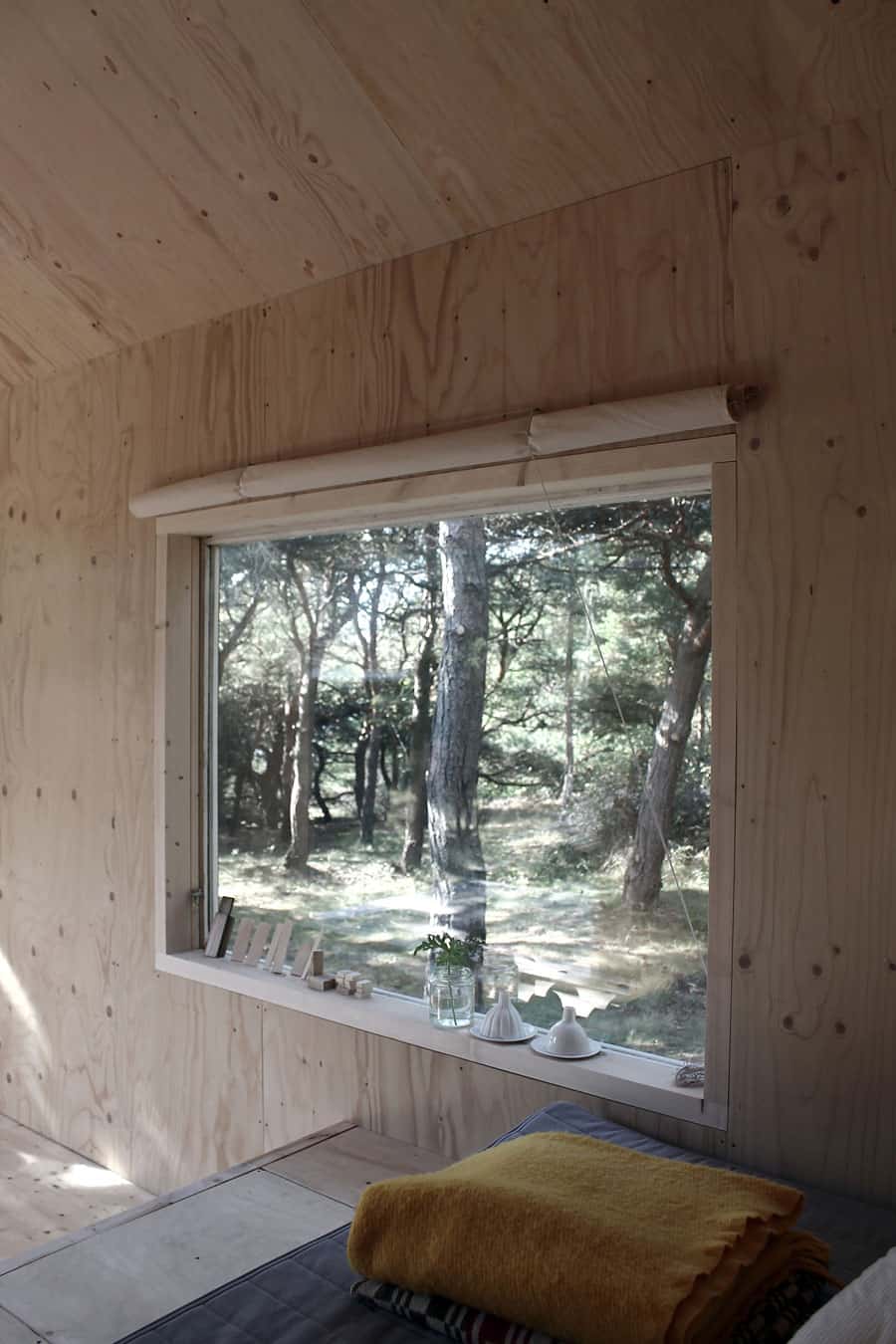 compact plywood pine cabin with attached sauna 11 back window