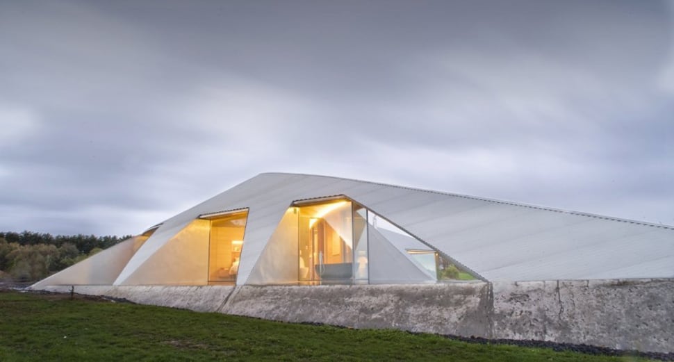 crescent shaped croft house with curved roof and windows 5