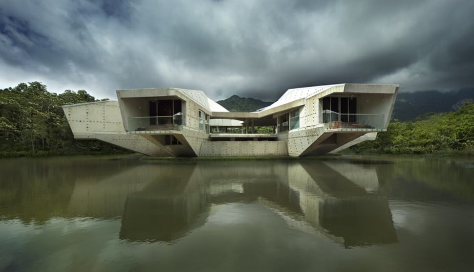 futuristic concrete house with bridge access and eco appeal 4