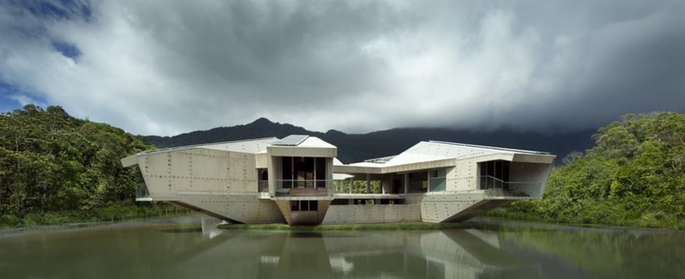 futuristic concrete house with bridge access and eco appeal 5
