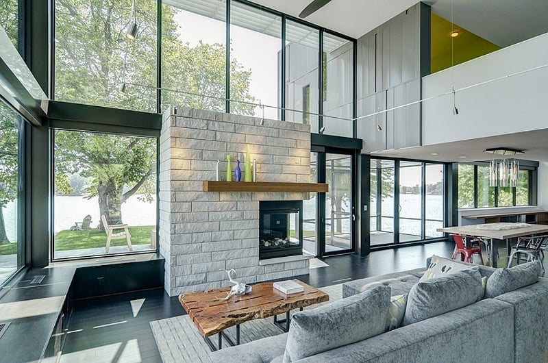 glass lake house features modern silhouette of earthy materials 10