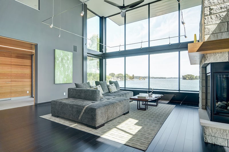 glass lake house features modern silhouette of earthy materials 8
