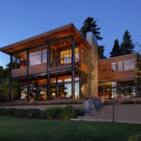 Grand glass lake house with bold steel frame