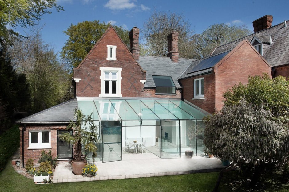 historic brick house with modern glass wing and interiors 1