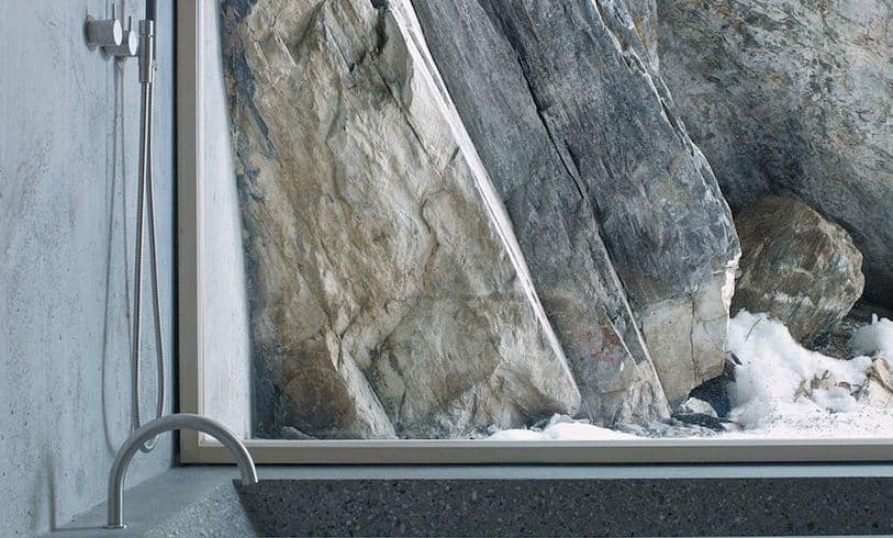 minimalist-concrete-alpine-cabin-7-window-rocks.jpg