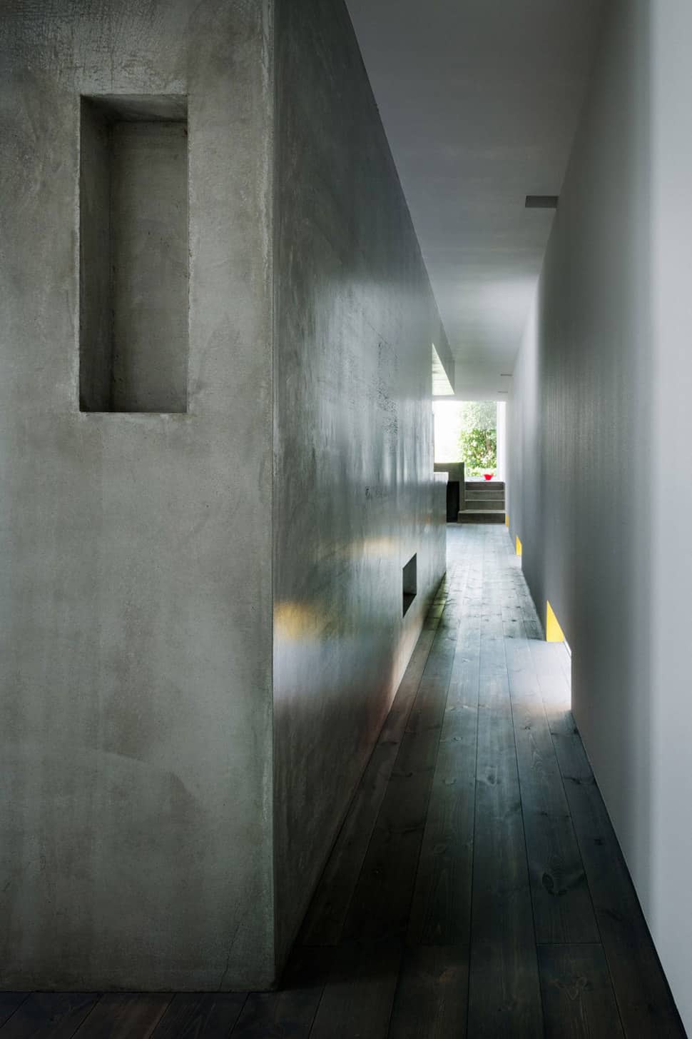 narrow urban home with concrete walls and upper bridge 6