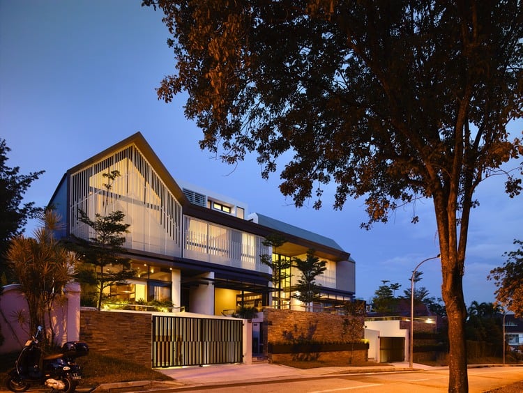 slatted facade house with sleek adjoined apartment 2 evening from street