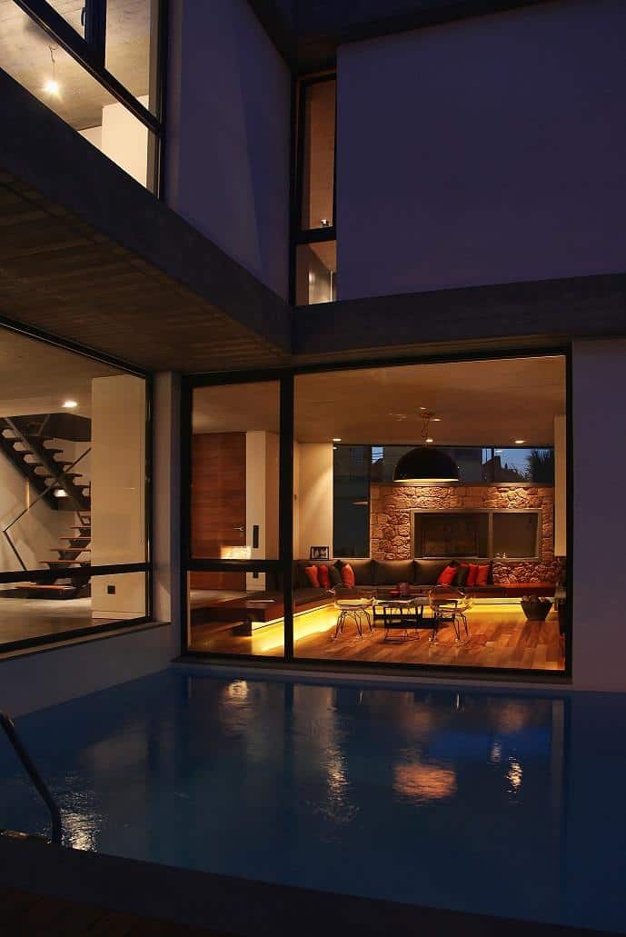 sleek-athens-house-blends-stone-with-concrete-textures-14-deck-inward-living-room.jpg