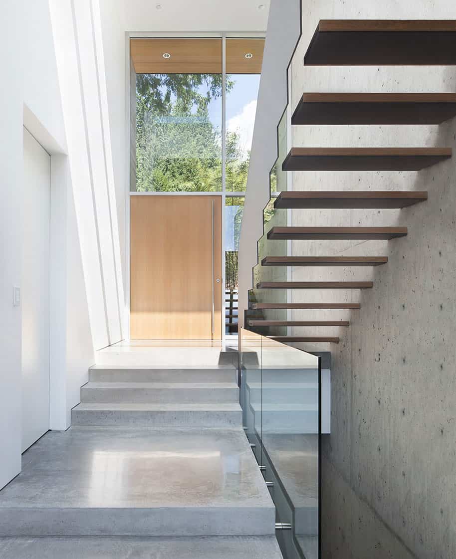 sleek slope house with interior featuring concrete 7 inside entrance