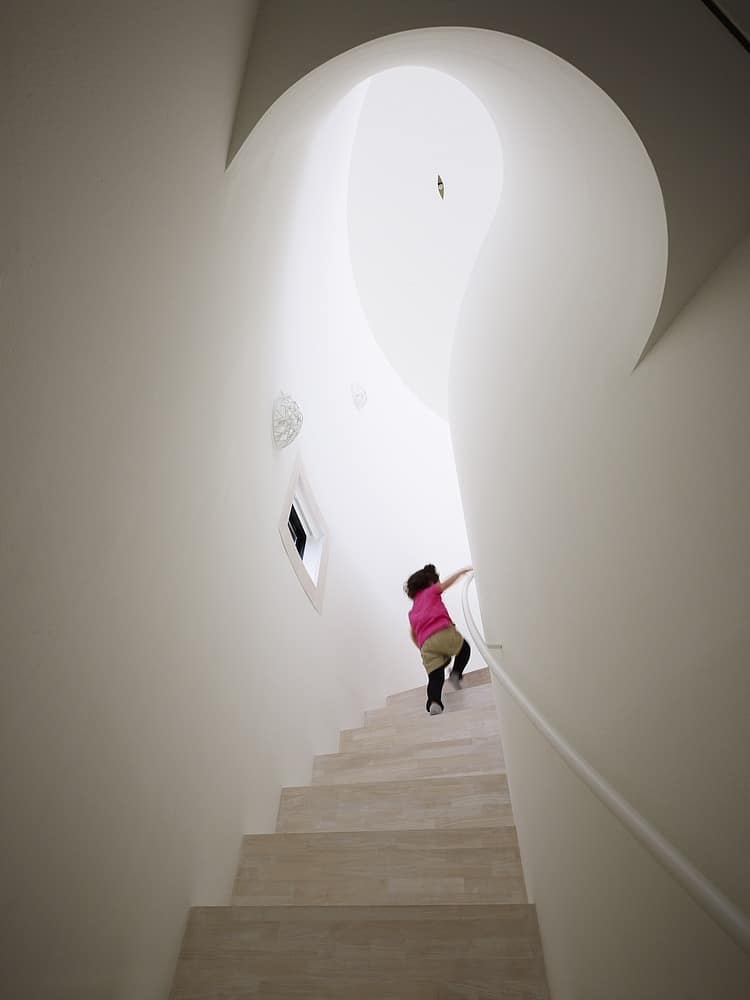 spacious oval plan hiroshima home uses light creatively 8 curved stairs