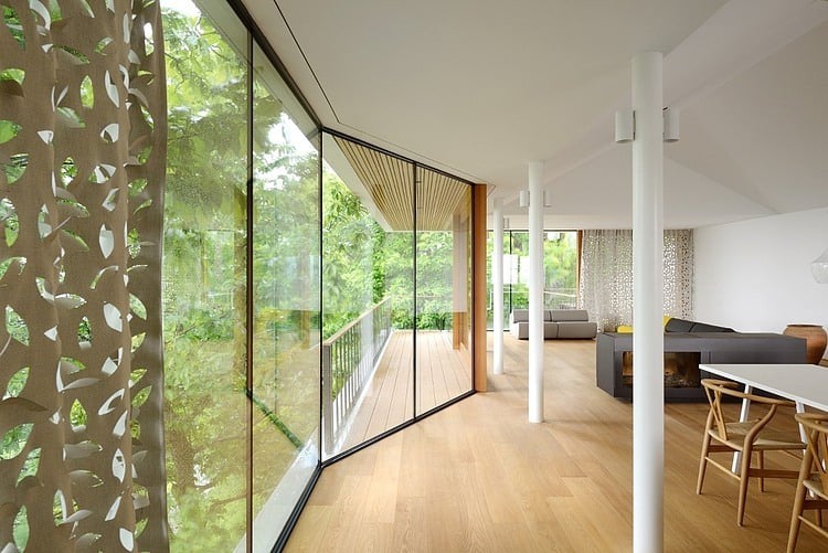 timber slope house lined with glass walls and terraces 5