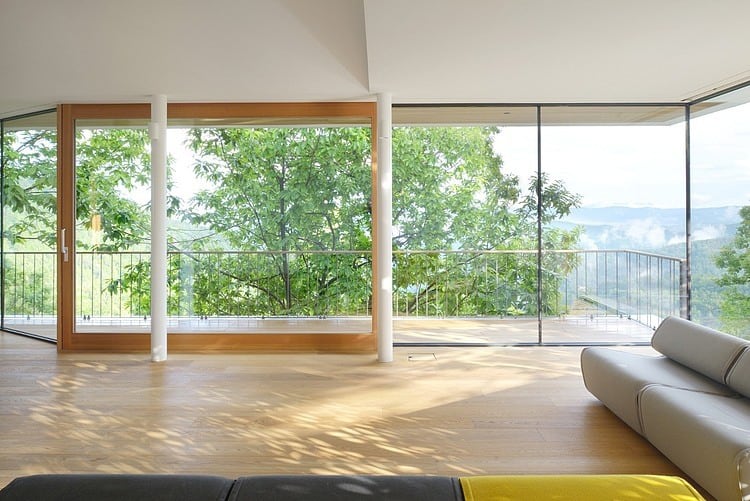 timber slope house lined with glass walls and terraces 6