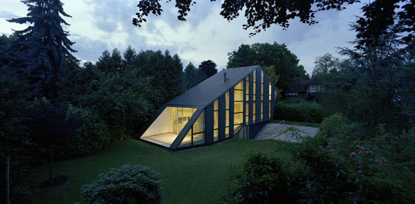 unusual shaped house with glass facades in german garden 1