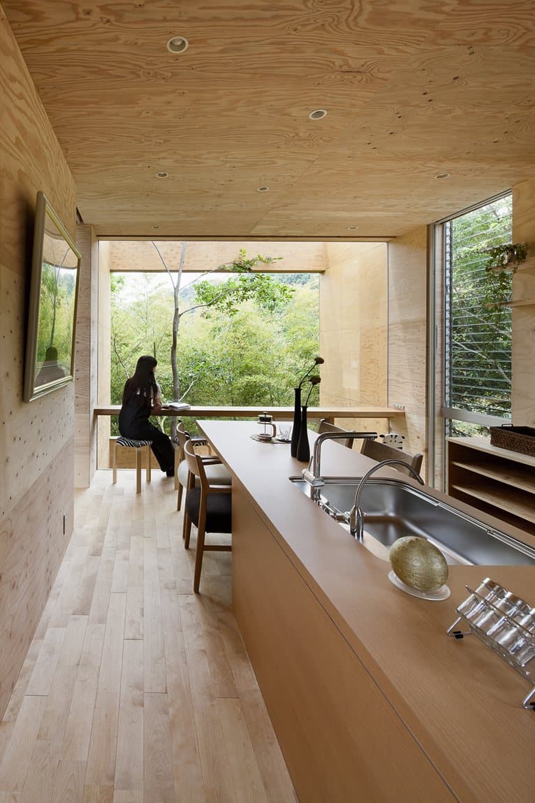 various wood finishes populate uniquely natural japanese home long outward kitchen view