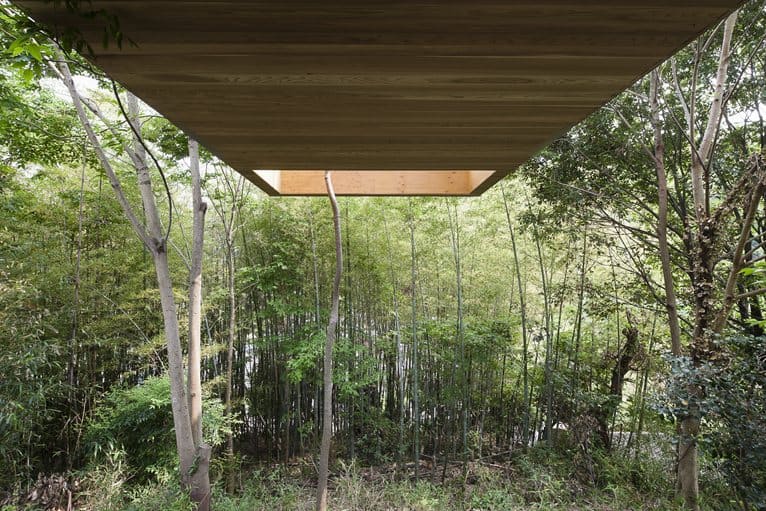 various wood finishes populate uniquely natural japanese home overhang from below