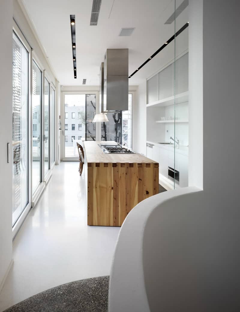 white shades define luxurious multistory milan apartment 8 kitchen far