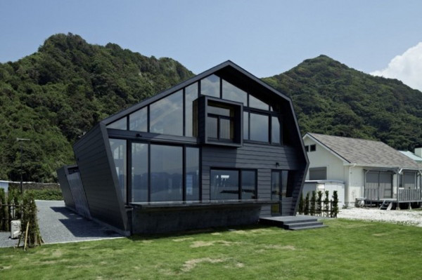 Wood and glass house with ocean and mountains for neighbors