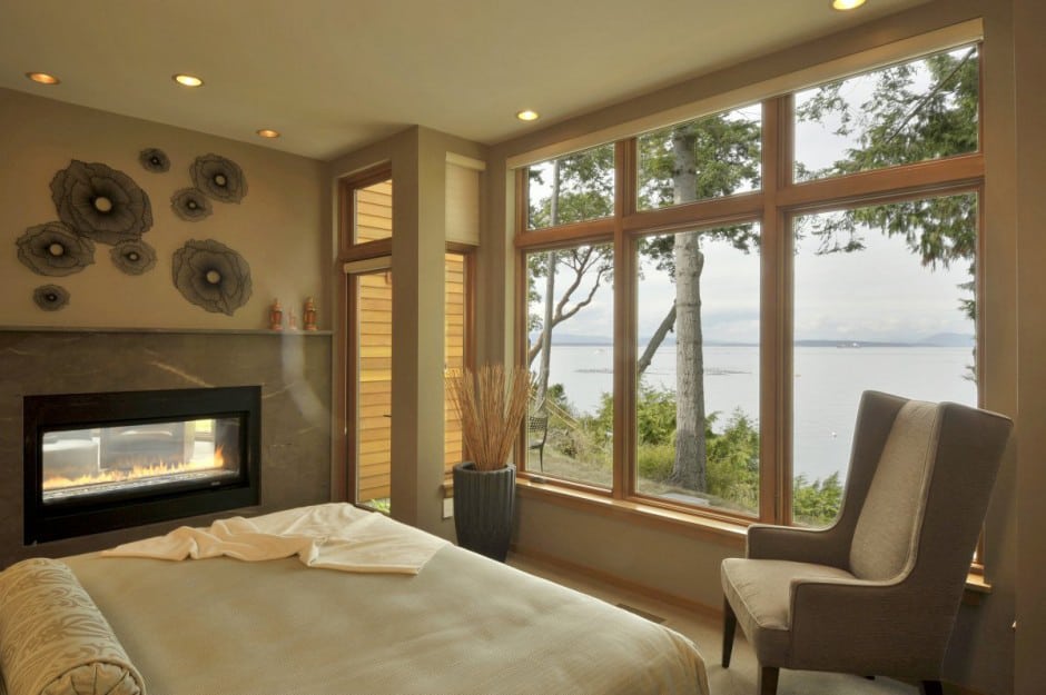 wood house with curved glass walls overlooking sunset bay 16