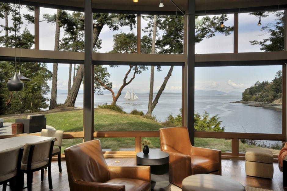 wood house with curved glass walls overlooking sunset bay 8