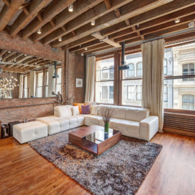 Open Plan Apartment with Exposed Wood Beams and Iron Columns