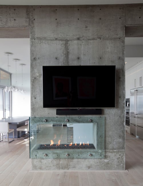 double sided modern fireplace room divider concrete and glass