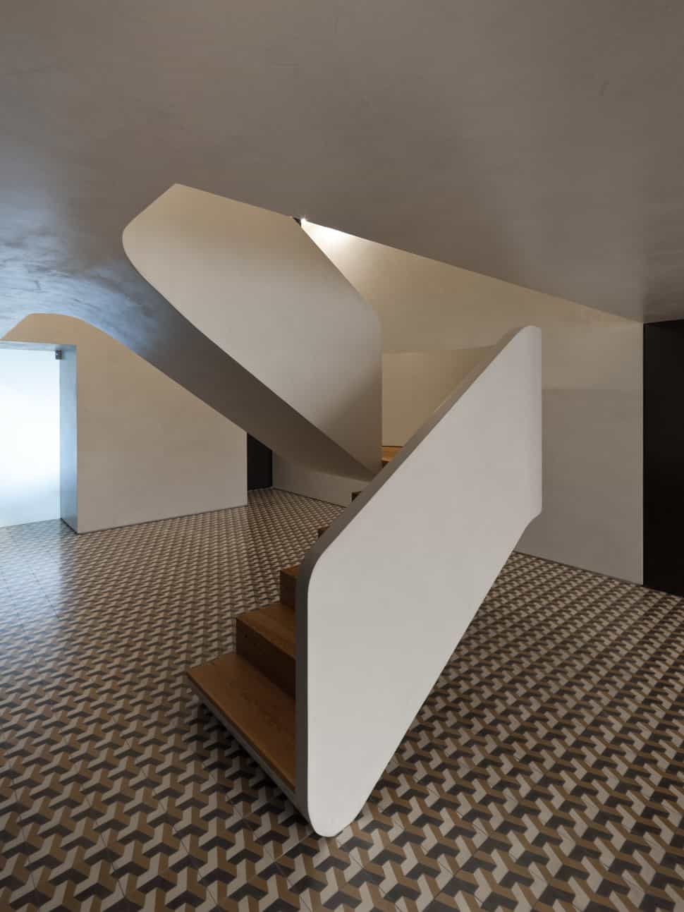minimalist home with bold flooring and staircase sculpture 8