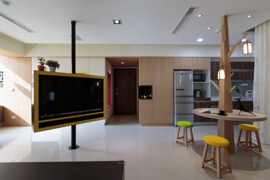 pivoting tv turns playful apartment into entertainment area 4