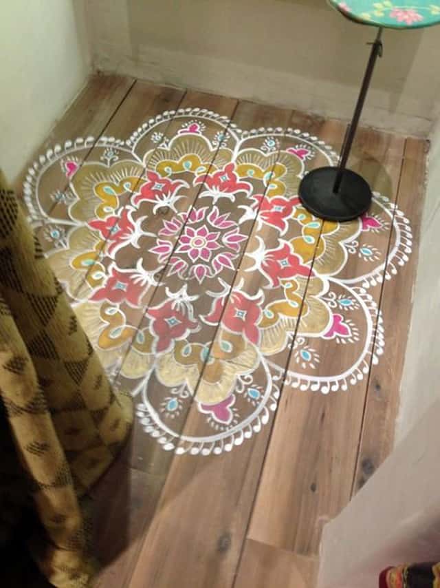 small color rug painted on wide plank floor